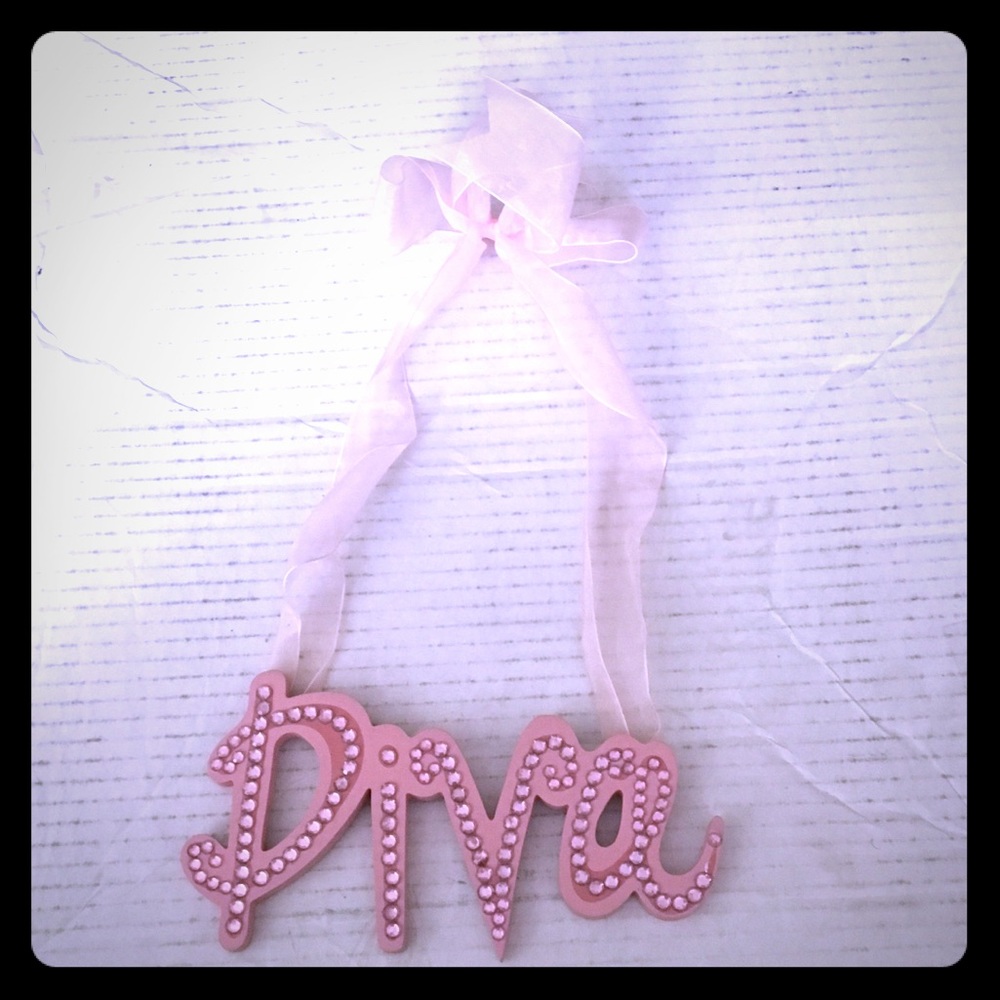 Pink Diva wall hanging. Missing one pink stone.